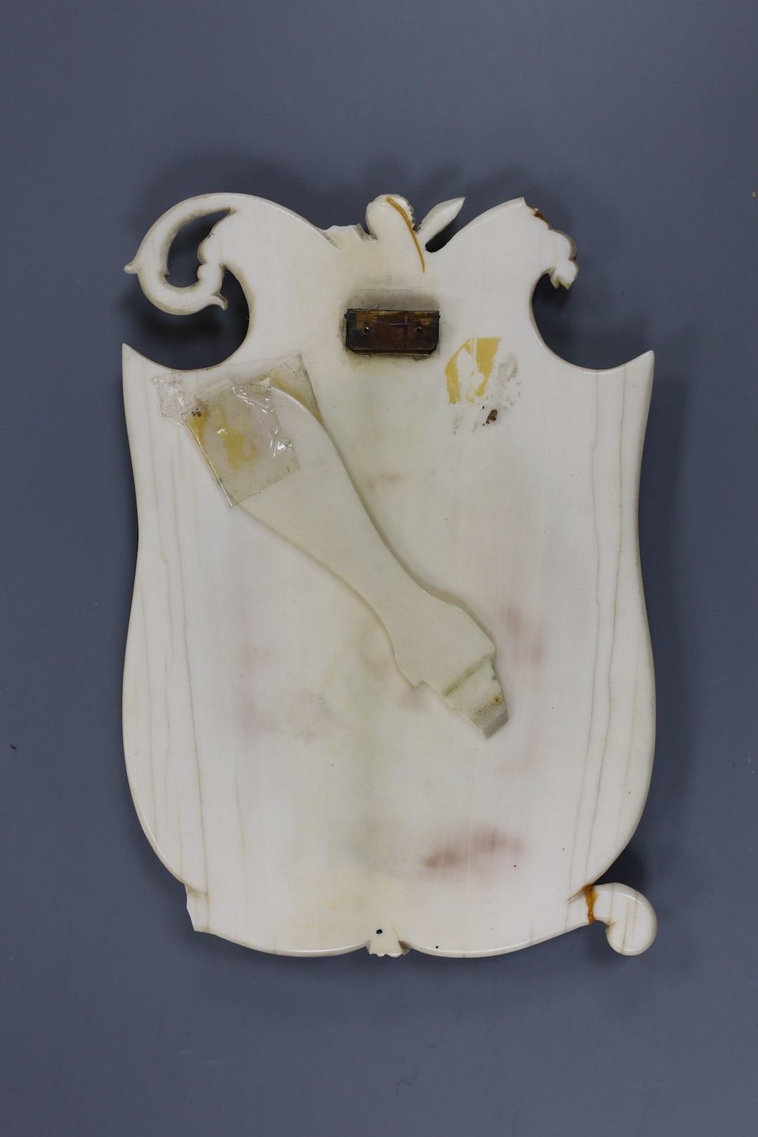 A 19th century carved ivory frame housing an indistinctly signed portrait miniature of a lady 14cm high.